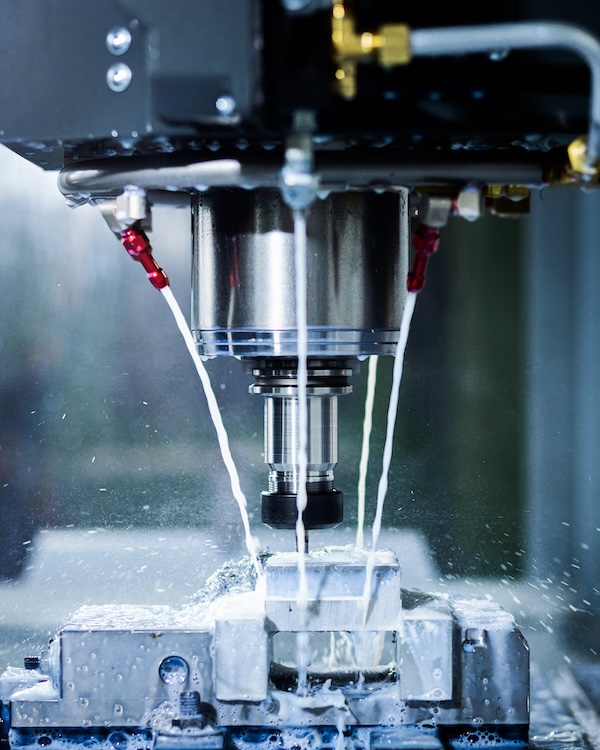 Close up of CNC machine cutting metal.